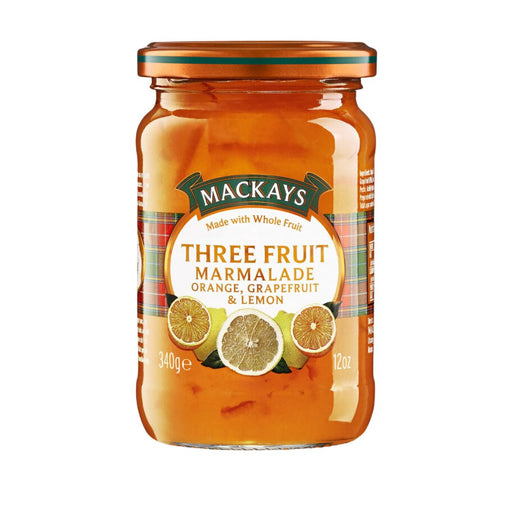 A jar of Mackays Three Fruit Marmalade containing orange, grapefruit, and lemon flavors, with a gold lid and a white and green label, set against a plain white background.