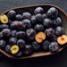Plum fruits on a dark surface